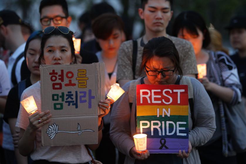 People gather during a vigil in downtown Seoul to remember victims of the shooting at an Orlando nightclub on June 13, 2016 in Seoul, South Korea.